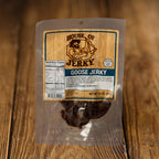 a bag of goose jerky on a wood background