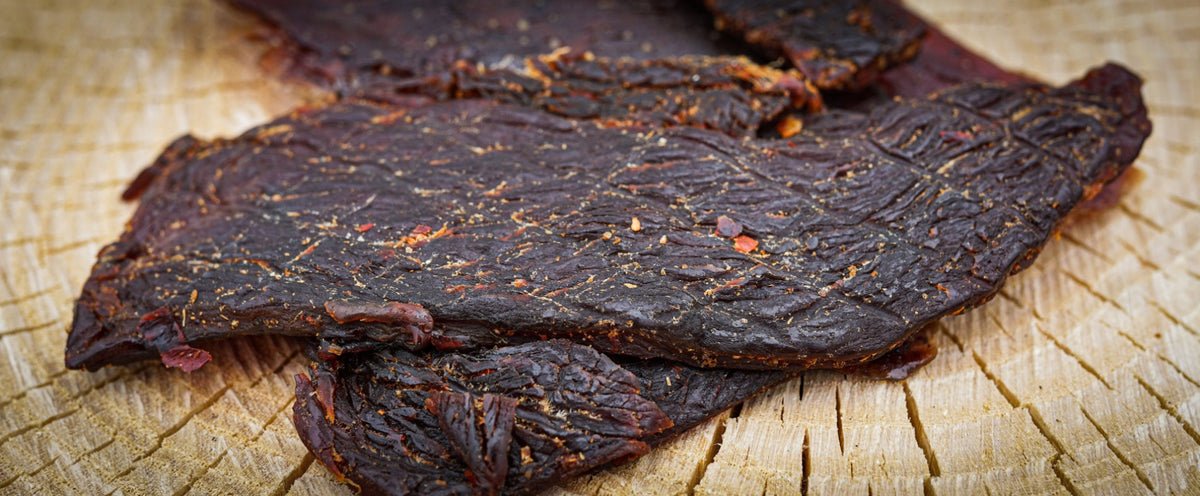 slices of jerky with text overlay that says, The Way Jerky is supposed to taste - Whole cuts of prime meat. Like a steak in your pocket.